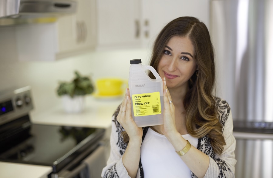 Melissa holding a bottle of vinegar