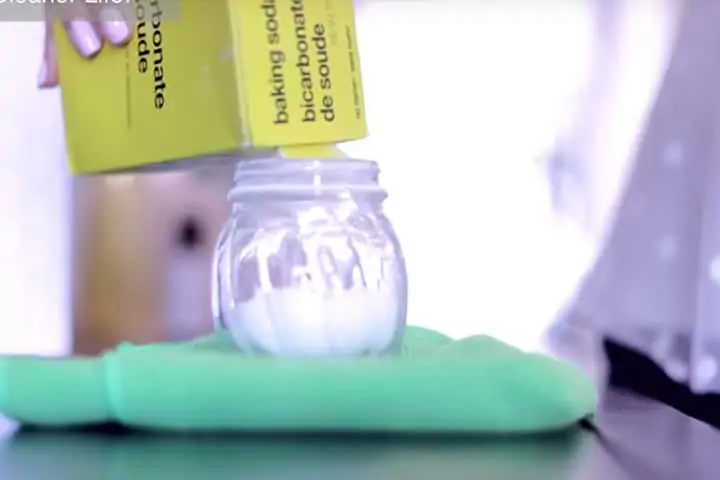 Baking soda pouring into a jar