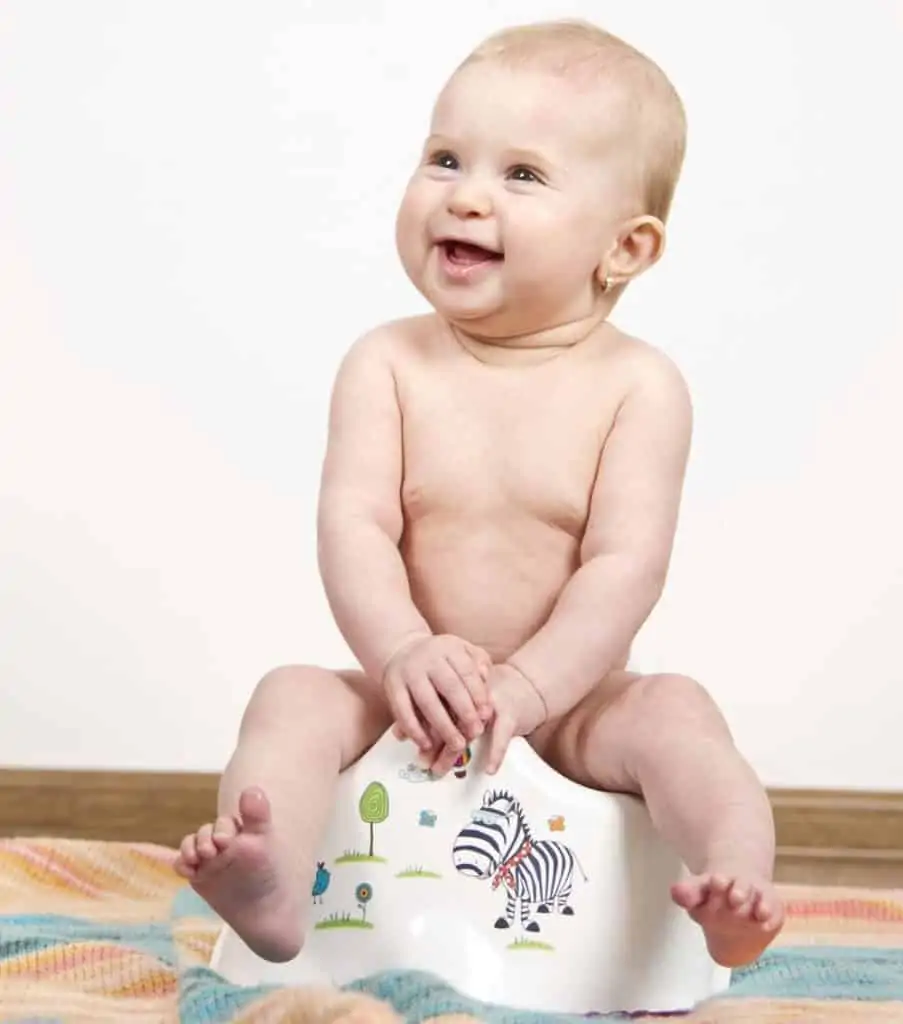 Baby using a potty chair