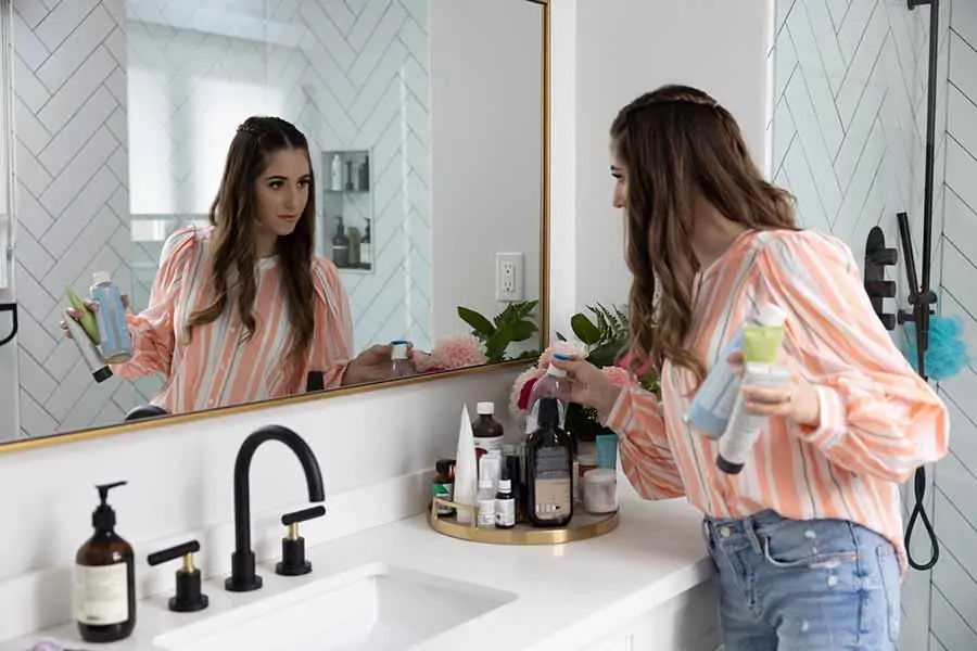 Melissa Maker organizing bathroom products on a tray