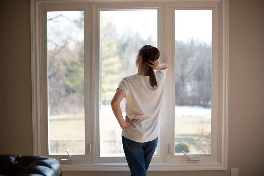 Melissa Maker standing at window