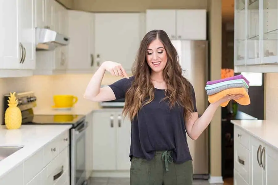 Melissa Maker in her kitchen holding microfiber cloths