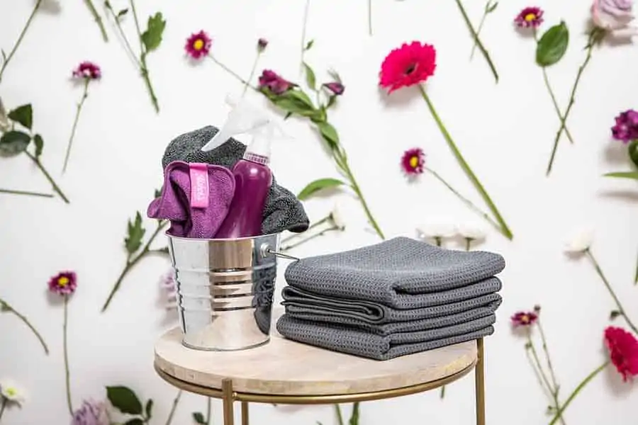 cleaning supplies against a wall with flowers